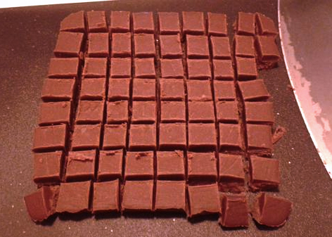Make 'em whatever size you want. Heck, you could just cut 'em into long sticks, or get a cookie cutter, or, I dunno, make individual shapes that you can use to build a little fudge house or something. Have fun. Oh! And this is VERY important: Be SURE to eat a few pieces at this stage. Quality control is very important here, especially if you're going to be sharing it with loved ones. Do you want to give them substandard fudge? No, of course you don't. Try as many pieces as it takes to be sure. Sometimes it's just not good enough for other people to have, and you have to eat it all and make a new batch. These are the sacrifices we who bear the fudge must make, people.